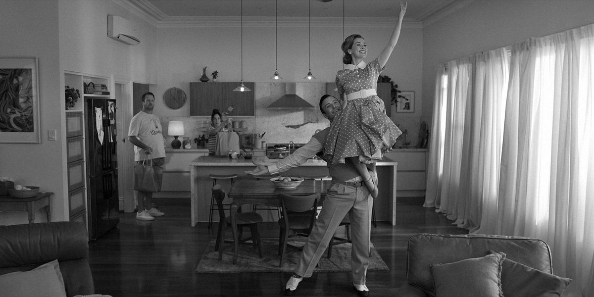 Episode #401: a dancer lifted in a living room beside curtained windows