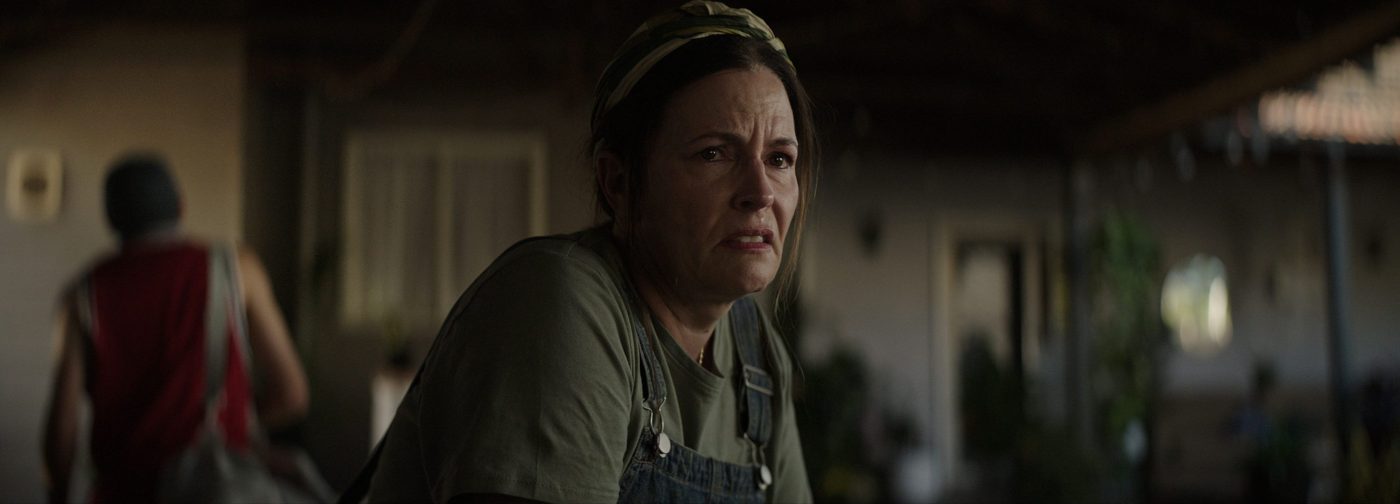 Episode #452: the mother in close-up, her son walking away behind her